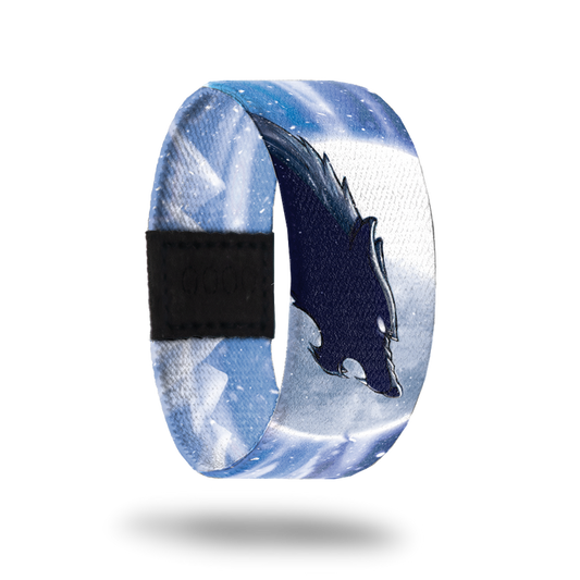 Outside is white and blue snowstorm with a black wolf howling at the sky