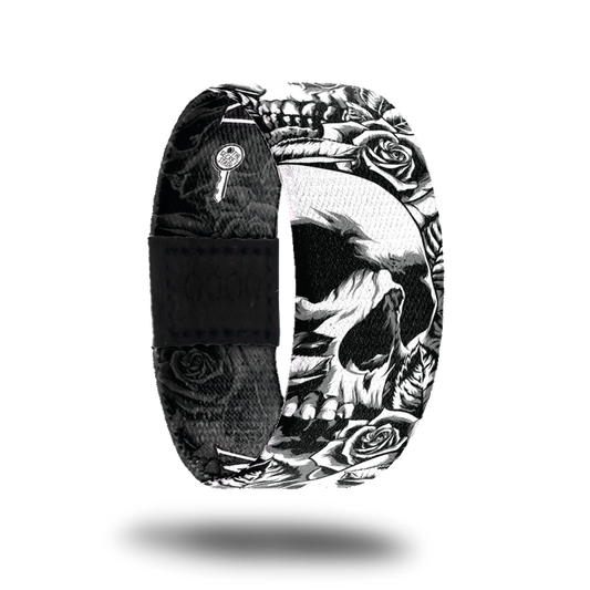 Outside is a black and white design of a detailed skull surrounded by leaves and roses.