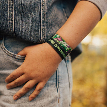 Closeup of someone with their hand in their pocket while wearing the band.