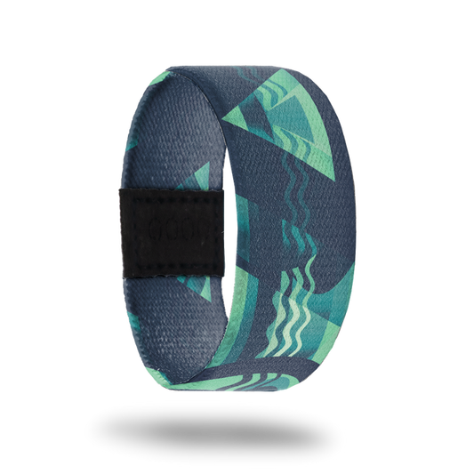 Outside is abstract design of triangles and waves in colors of dark green, sea foam green and white.
